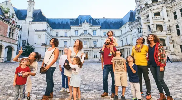 Famille émerveillée devant l'architecture du château de Blois, un lieu chargé d'histoire.