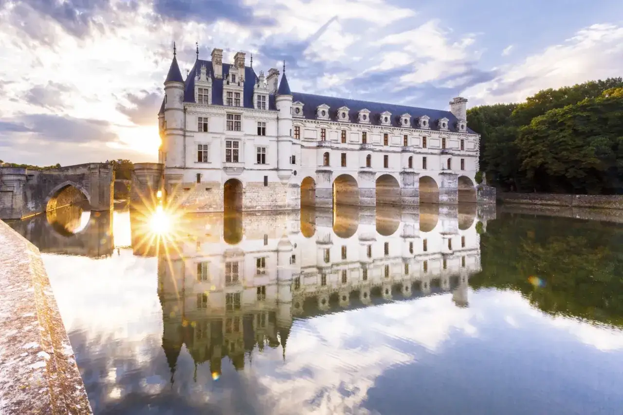 Le ch&acirc;teau de Chenonceau, reflet d'un coucher de soleil sur l'eau. Id&eacute;al pour le temps de visite.