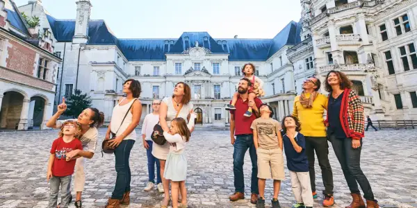 Famille émerveillée devant l'architecture du château de Blois, un lieu chargé d'histoire.